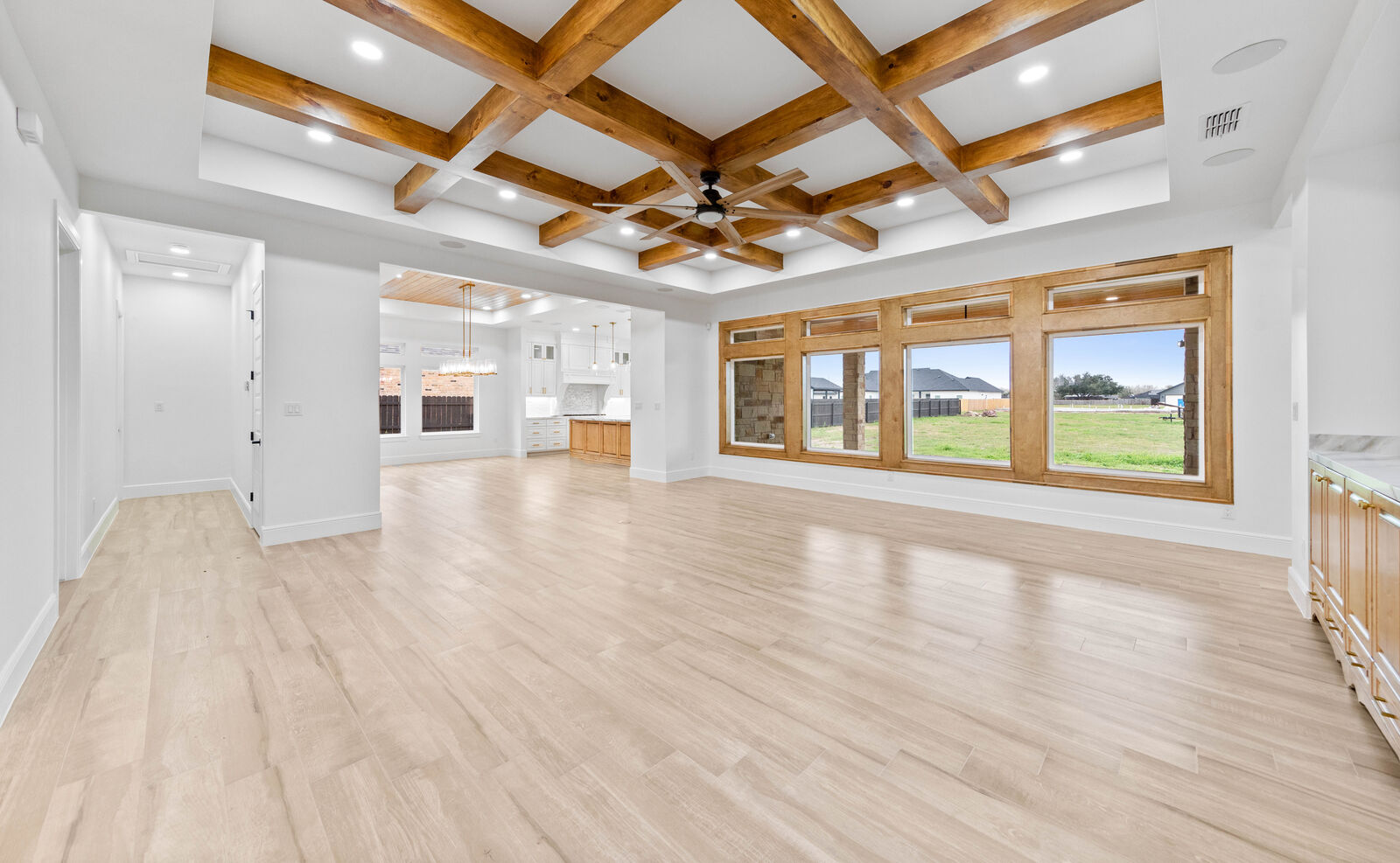 Sun-lit great room with large energy-efficient windows in a Cano custom home